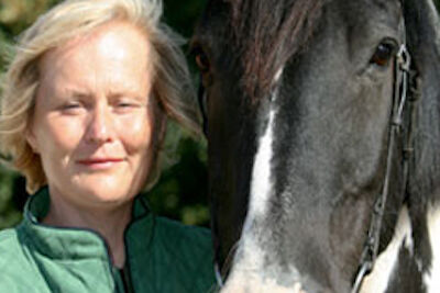 woman standing with a horse